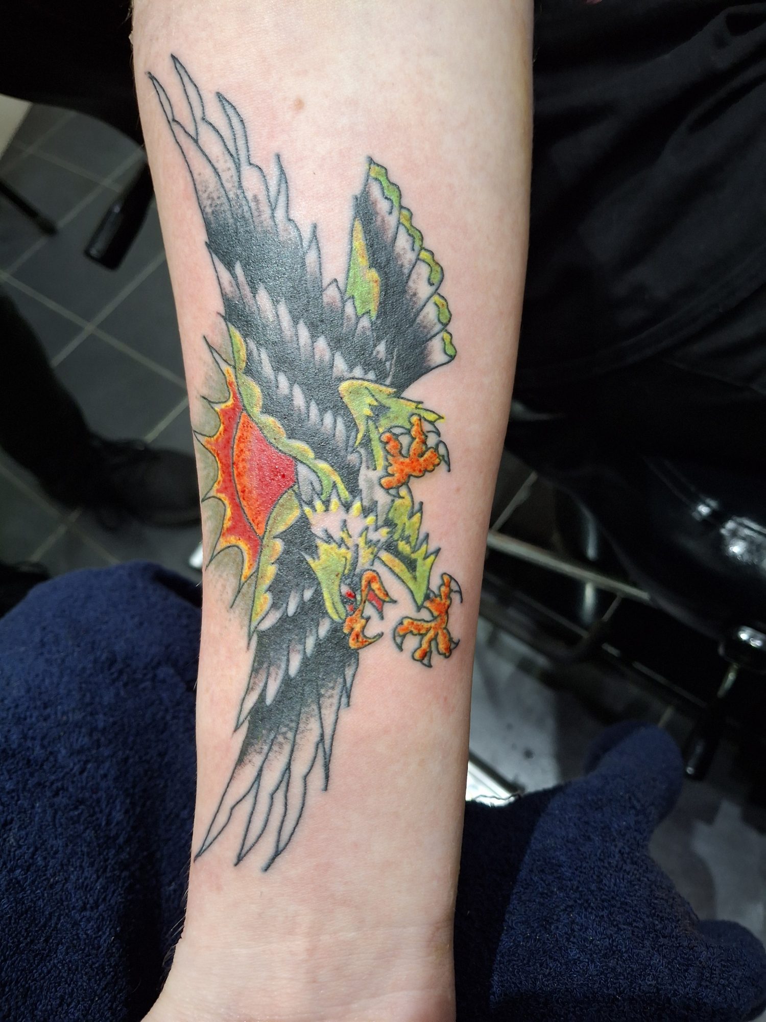 Green and black eagle tattoo