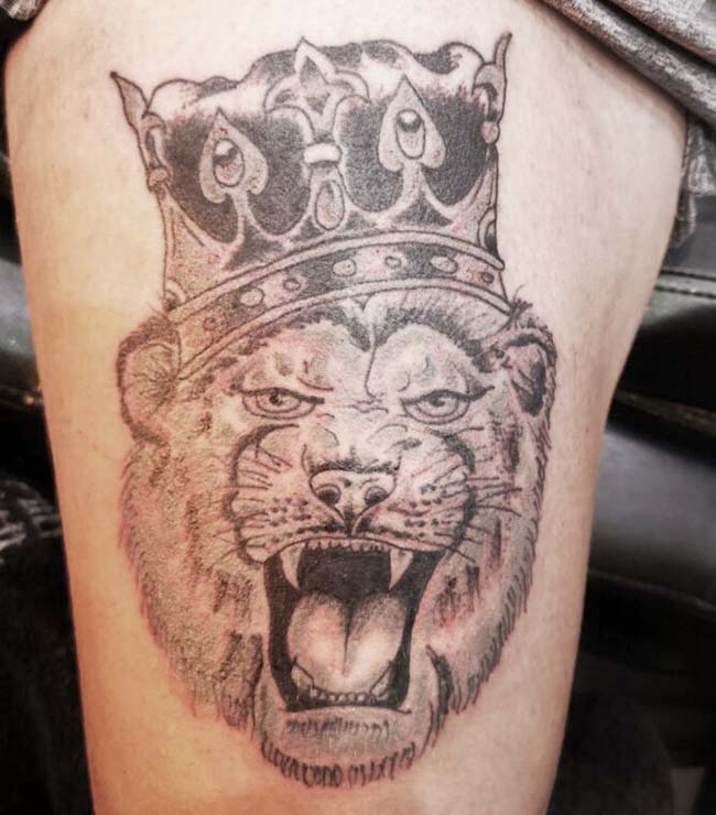 Lion with crown tattoo